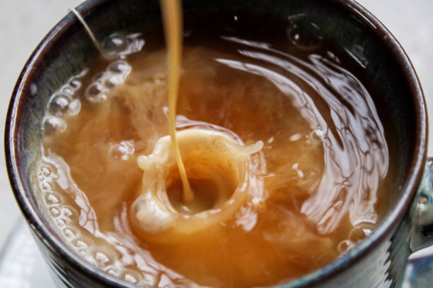 istock Drops of milk splashing into tea or coffee 1305343671