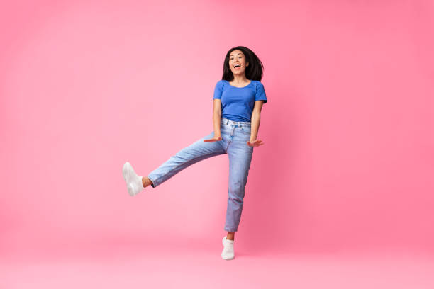 istock Happy young asian lady jumping at studio 1305344459