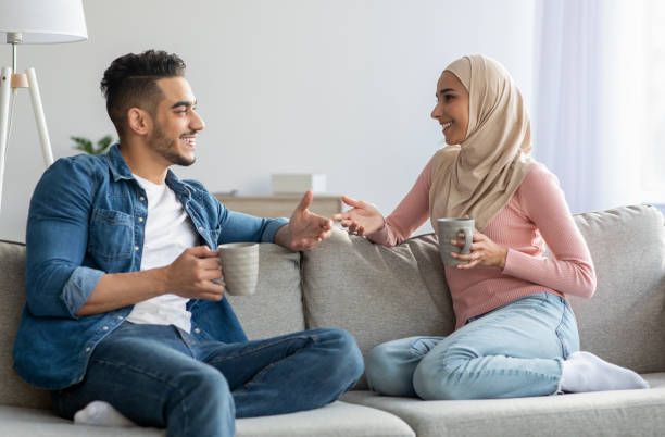 istock Muslim couple drinking tea and talking at home 1305344605