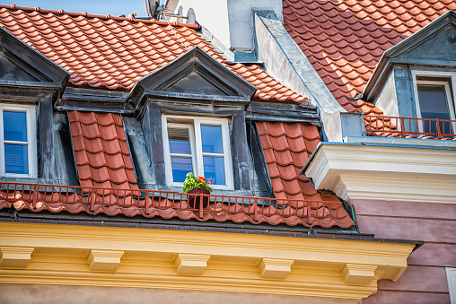 Warsaw, Poland old town castle square with historic street architecture and blue red window roof rooftop closeup pattern summer flowers