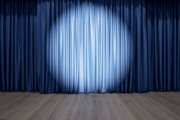 istock Round spotlight on blue curtain on the stage with wooden floor 1305346721