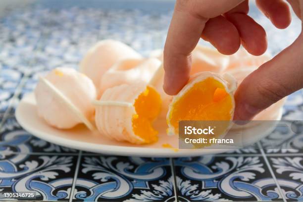 Hand Taking A Traditional Portuguese Sweet Called Ovos Moles De Aveiro Stock Photo - Download Image Now