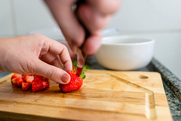 istock Woman slicing strawberries to make compote 1305346867