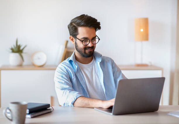 istock Smiling Arab Man Self-Entrepreneur Working With Laptop At Home Office 1305346871