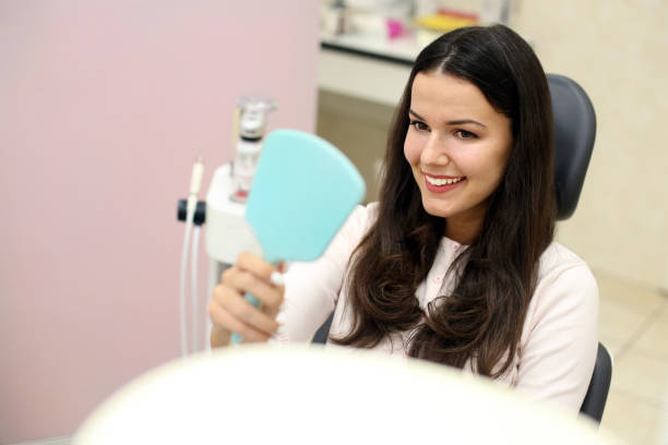 istock Young woman looking at her new smile 1305347063