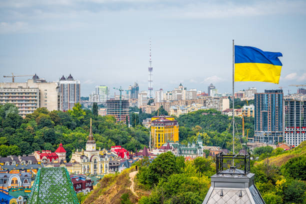 kiev, ucrania paisaje urbano de kiev y bandera ucraniana ondeando en el viento durante el verano en el distrito de podil y coloridos edificios nuevos - photography tower cityscape flag fotografías e imágenes de stock