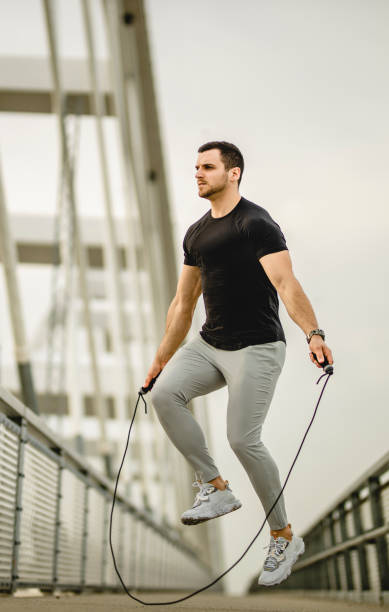 istock Portrait of a handsome young athlete using a skipping rope during an outdoor training session 1305347287