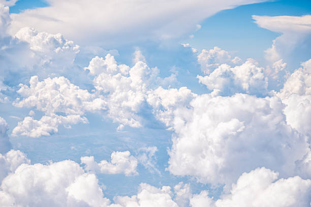 Above isolated view of sky cloudscape with fluffy clouds and bright soft sunny sunlight aerial view of Italy, Europe from airplane