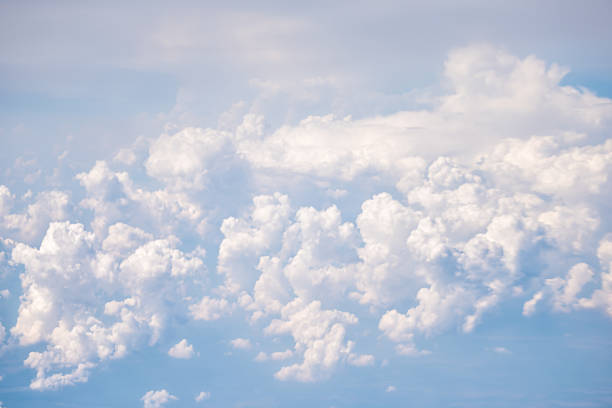 istock Above high angle aerial view of sky cloudscape with fluffy clouds and bright soft sunny sunlight of Europe from airplane 1305348126
