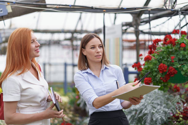istock Two business women having a conversation while visiting greenhouse 1305348188