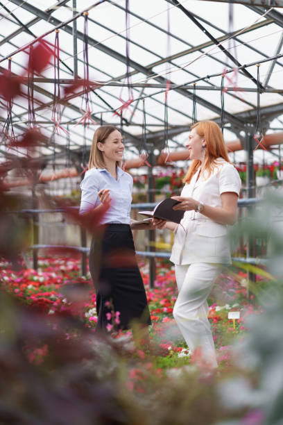 istock Two business women having a conversation while visiting greenhouse 1305348204