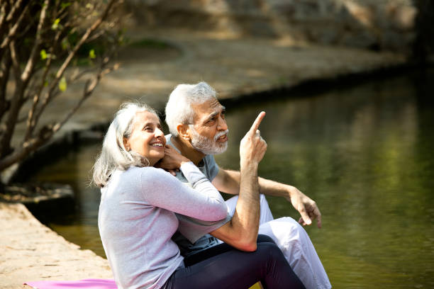 istock Senior couple admiring view at lakeshore 1305348312