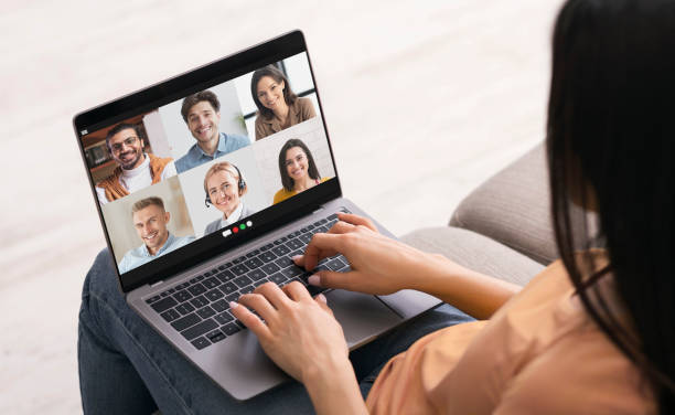 istock Distance communication. Young woman having online group conference with her work colleagues on laptop from home office 1305348380