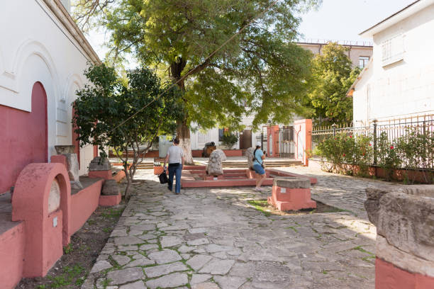 Tourists visit the open exhibition of the Feodosiya Museum of Antiquities. The courtyard of the oldest museum in Europe Russia, Crimea, Feodosia September 18, 2020-Tourists visit the open exhibition of the Feodosiya Museum of Antiquities. The courtyard of the oldest museum in Europe feodosiya stock pictures, royalty-free photos & images