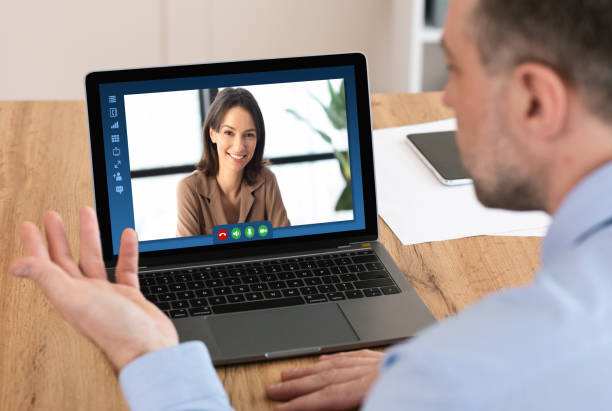 istock Male entrepereneur using laptop computer in office for online business meeting 1305349918