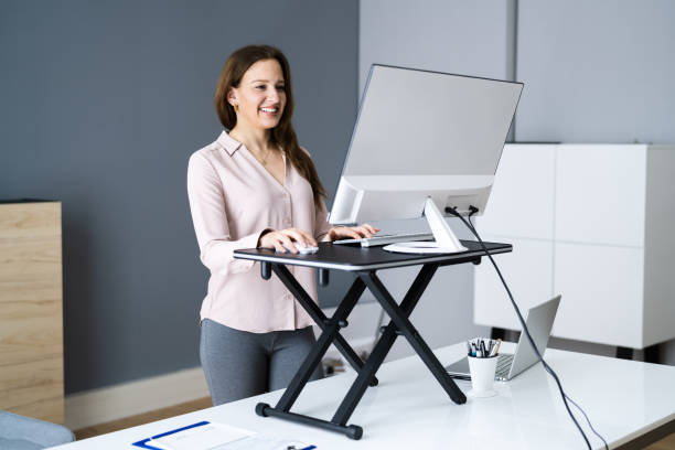 istock Adjustable Height Desk Stand In Office 1305350094