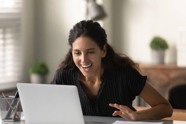 istock Close up surprised overjoyed woman looking at laptop screen 1305350131