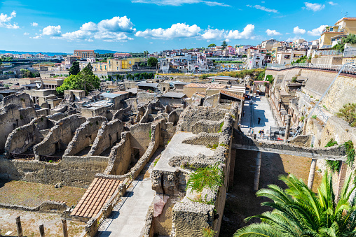 Herculaneum, Italy - September 6, 2019: View of the roman ruins of the ancient archaeological site of Herculaneum and the town of Ercolano, Italy