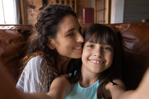 istock Small Hispanic girl take selfie with smiling mom 1305351022