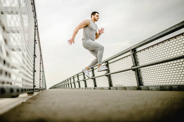 istock Young fit man exercising and running outdoors 1305351281
