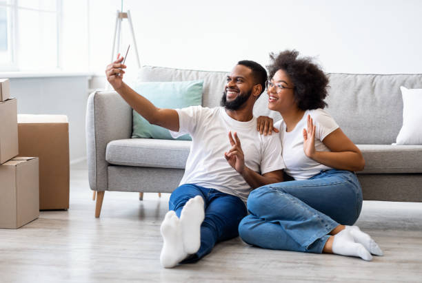 istock African Spouses Making Selfie Posing Among Moving Boxes Sitting Indoors 1305352392