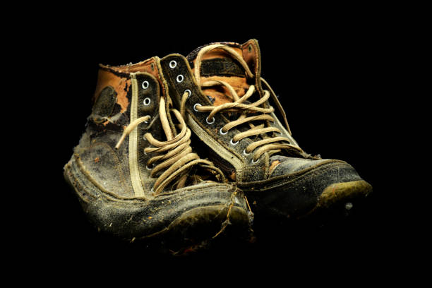 istock Very old sneakers on the black background 1305352442