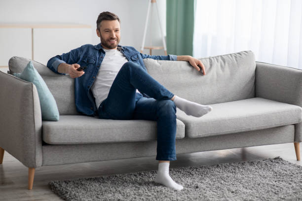 istock Relaxed man watching TV at home, copy space 1305352655