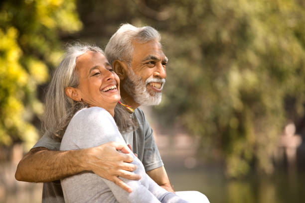 istock Loving senior couple spending leisure time by lakeshore 1305352730