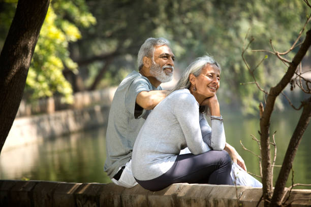 istock Loving senior couple spending leisure time by lakeshore 1305352911