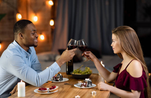 istock Happy Black Man And White Woman Having Romantic Dinner In Restaurant 1305353610