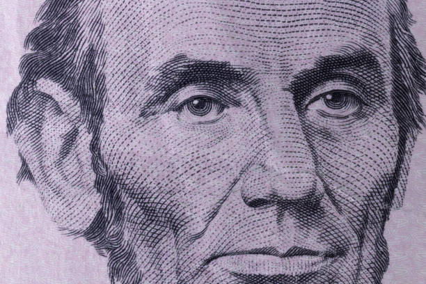 President Abraham Lincoln on the obverse of a five dollar bill for background. President Abraham Lincoln on the obverse of a five dollar bill for background. emancipation proclamation stock pictures, royalty-free photos & images