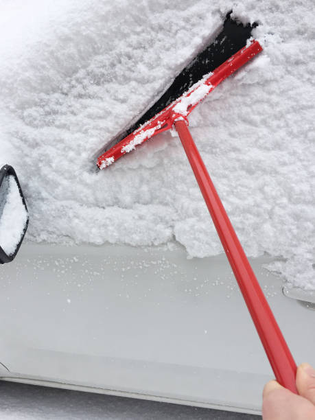 istock Cleaning the snow on the car 1305354230