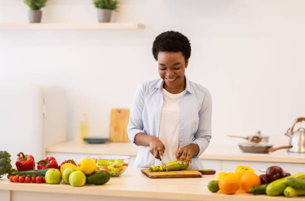 istock Cheerful Black Lady Cooking Preparing Dinner Standing In Kitchen Indoors 1305355616