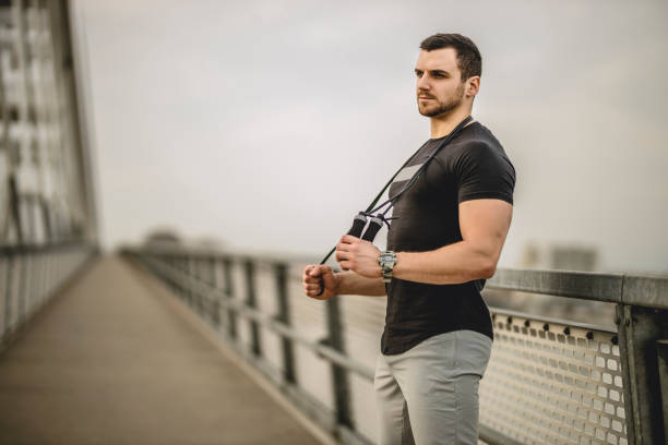Portrait of a handsome young athlete using a skipping rope during an outdoor training session