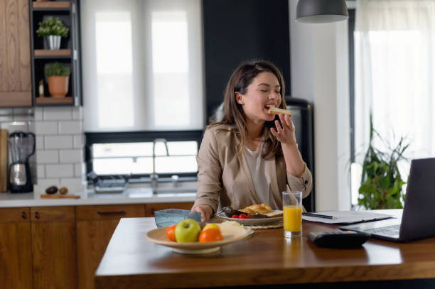 istock Young business entrepreneur woman working at home while having breakfast 1305357426