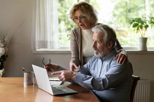 istock Senior couple using app at home, studying new online app 1305359997