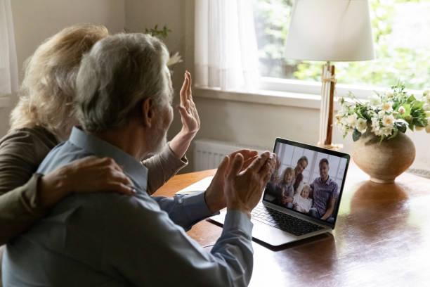 mature grandparents couple talking to children and grandchildren - aging process middle women men imagens e fotografias de stock