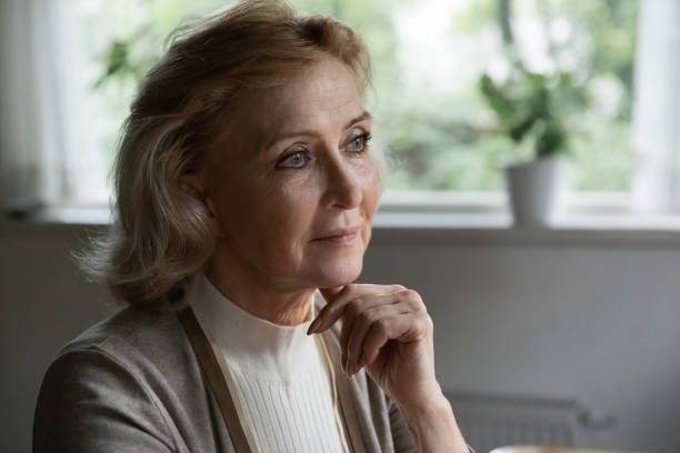 istock Pensive elder 60s retired woman looking away lost in thoughts 1305360585