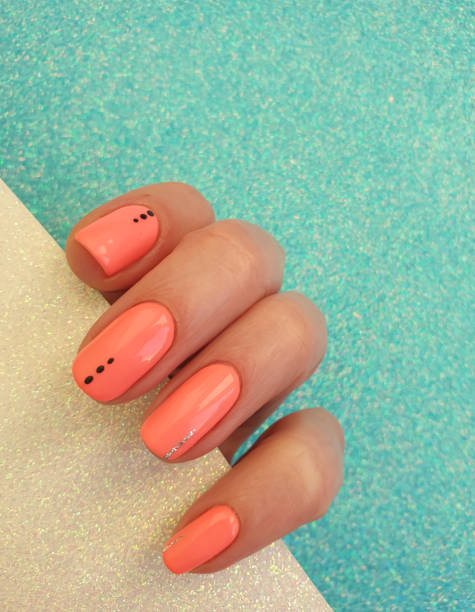 istock female hand beautiful manicure on a colored background 1305360846