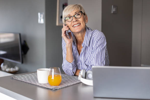 istock Modern senior woman working at home 1305361219