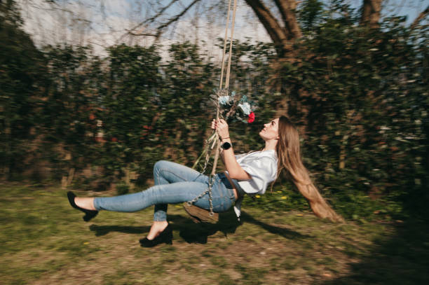 istock Young woman on a swing in motion 1305362115