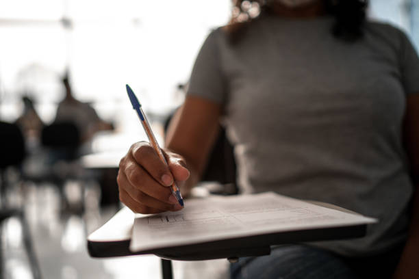 istock Female hands of a student taking a test 1305362771