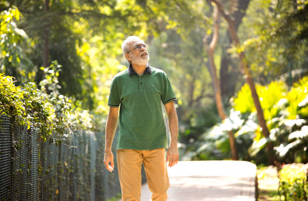 istock Senior man spending leisure time and admiring view at park 1305363013