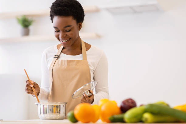 istock African Woman Cooking Dinner Standing In Modern Kitchen At Home 1305364021