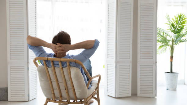 istock Back rear view young caucasian man relaxing on comfortable chair. 1305364177