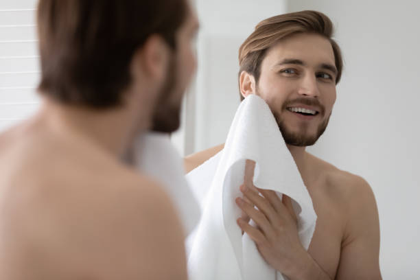 istock Smiling 30s young caucasian man wiping face with mirror. 1305364207