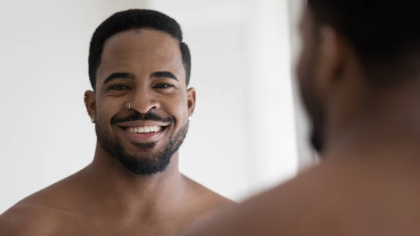 istock Smiling millennial african american man looking in camera. 1305364256