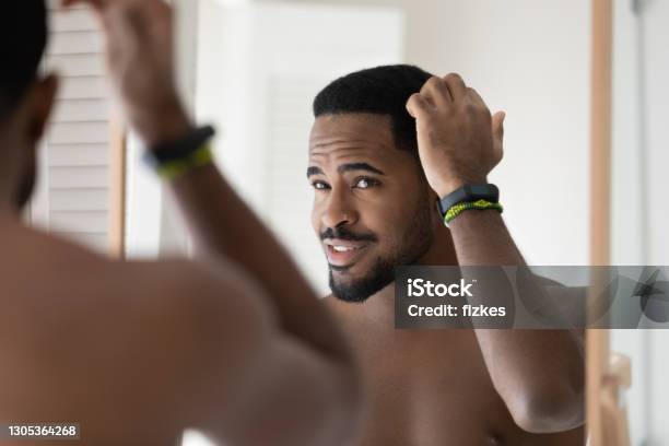 Happy Young 30s Handsome African American Bare Man Styling Hair Stock Photo - Download Image Now