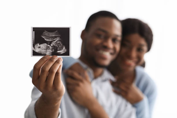 istock Baby sonogram in happy black couple hands 1305364620