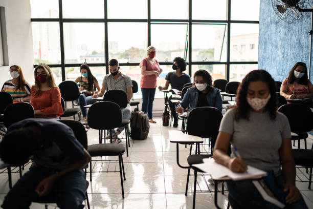 istock General view of students in classroom - wearing face mask 1305365542